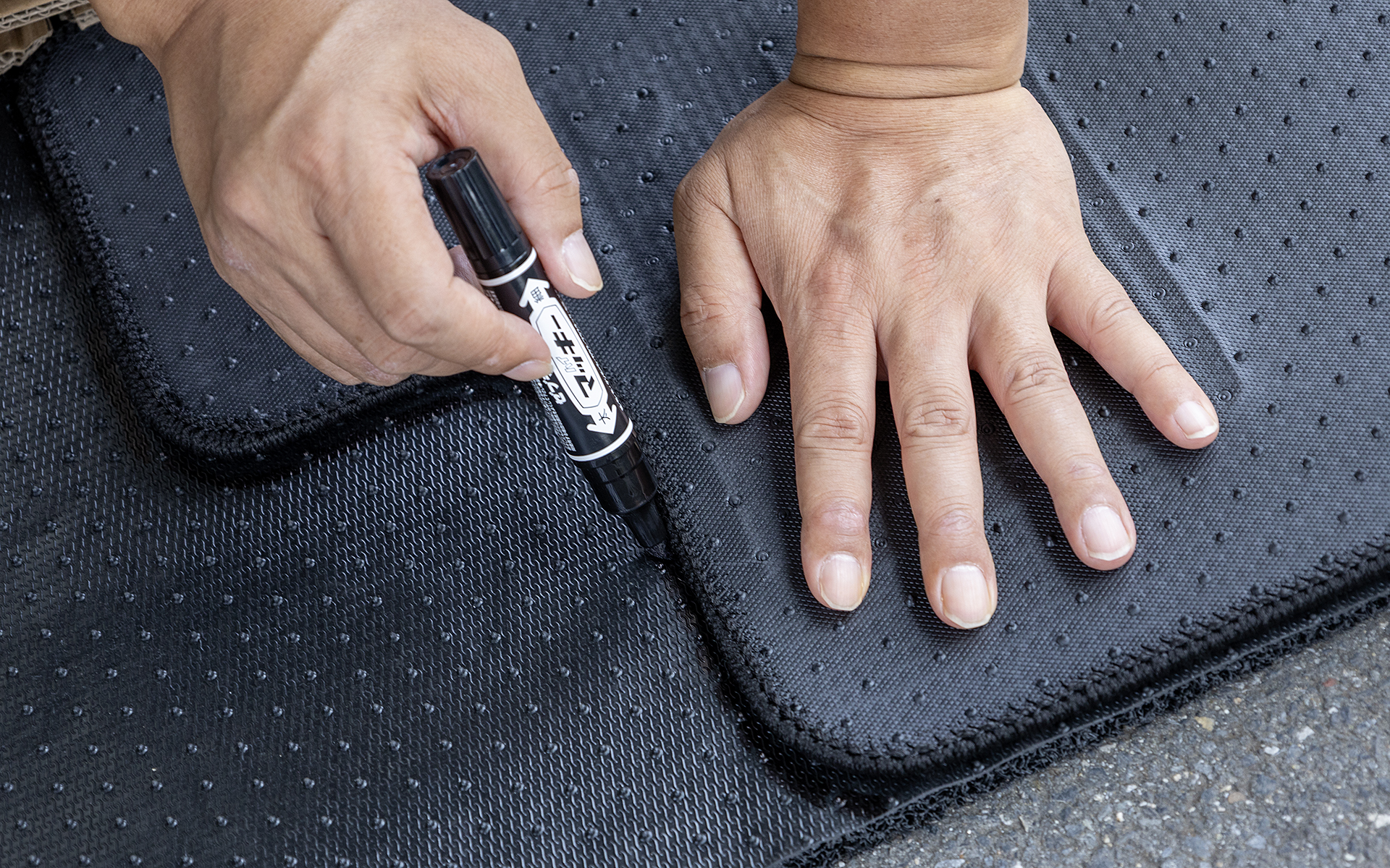 サイレントマット（裏側）にフロアマットを押し付けてカタチに沿ってマジックで線を引いていく