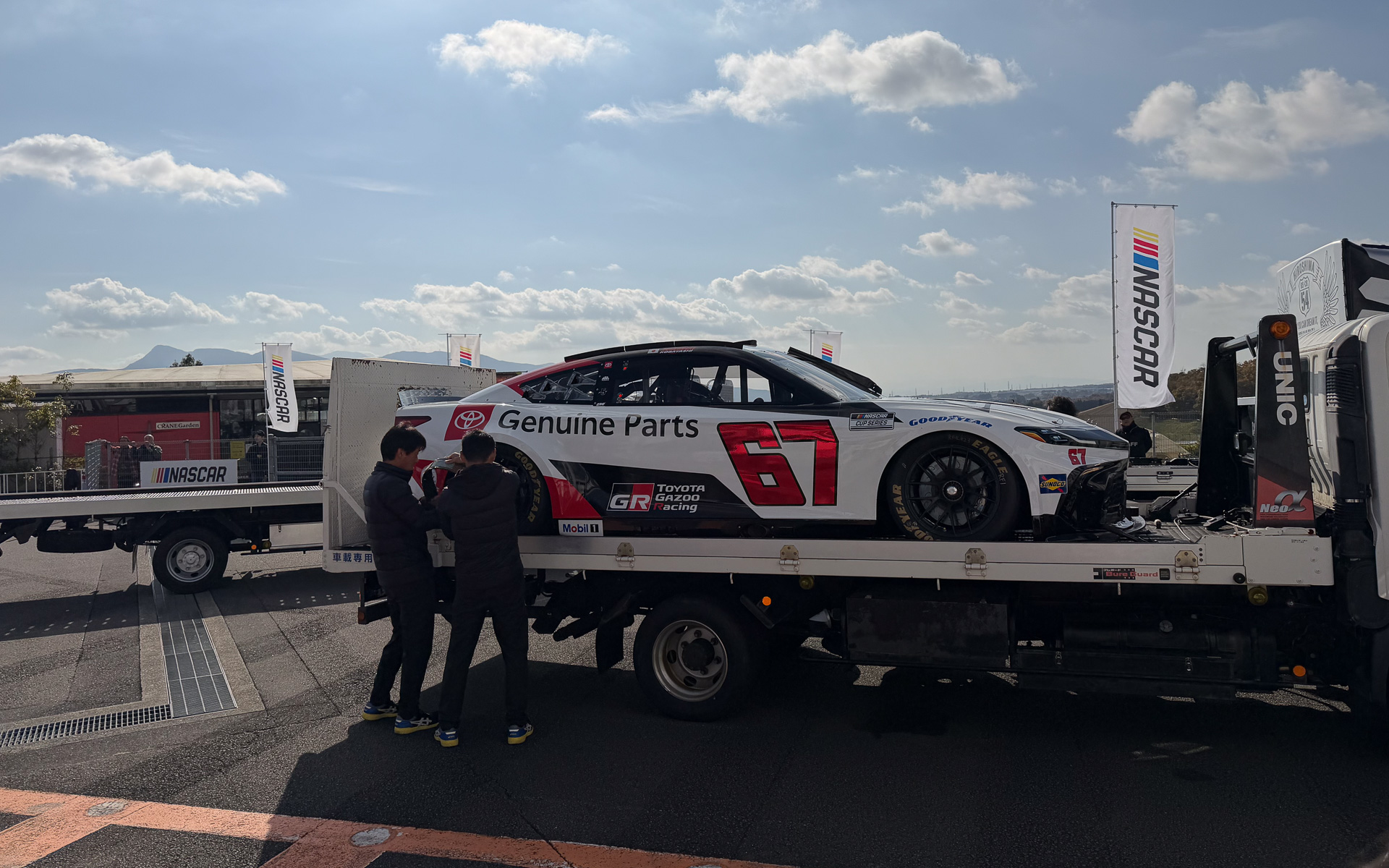 トランプ米国大統領来日時に迎賓館に置かれていたあのNASCARマシンを富士スピードウェイに搬入中。この67号車を小林可夢偉選手がドライブする。このマシンは迎賓館カムリとでも呼べばよいのだろうか？