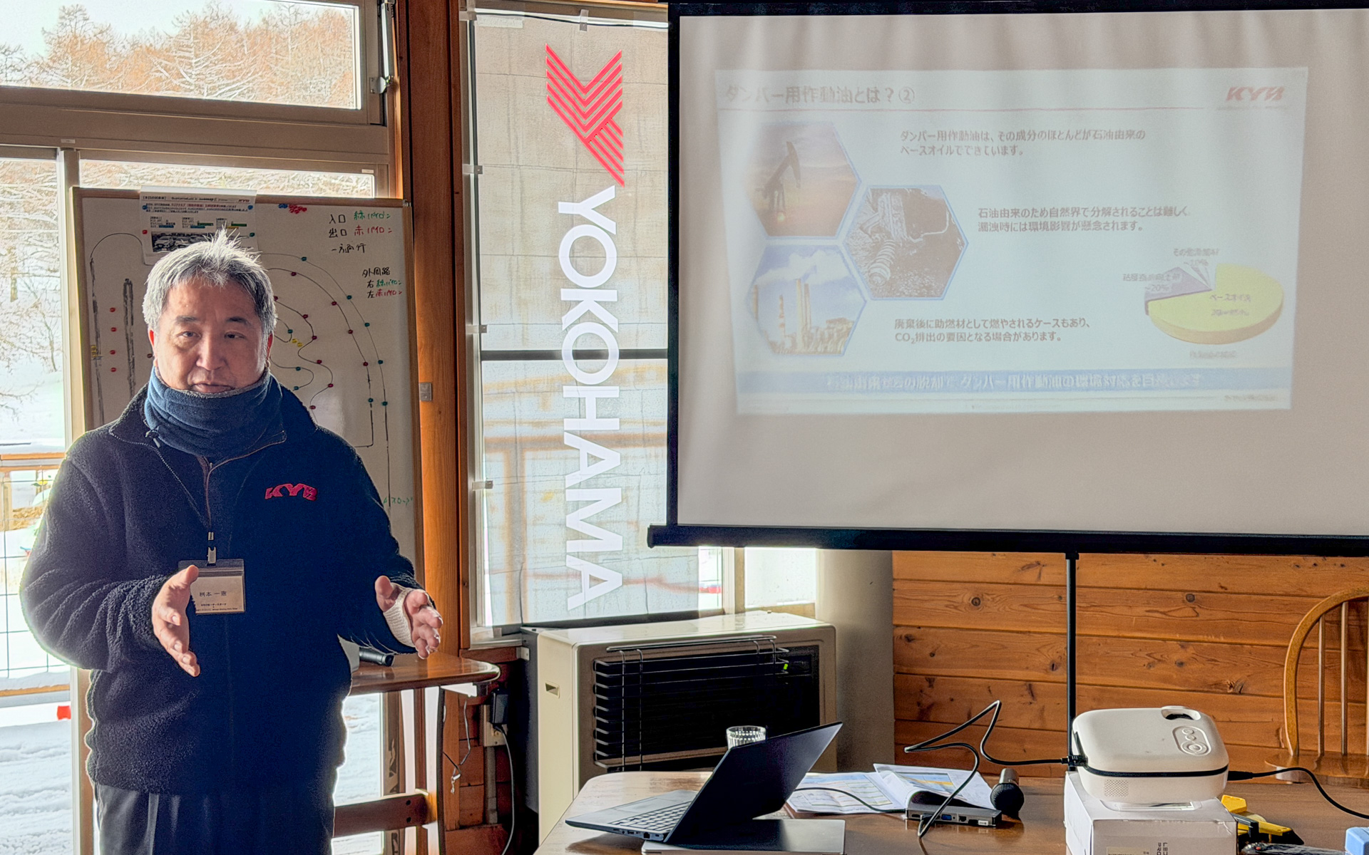 参加者にサステナルブ（環境作動油）について特徴を説明するカヤバ株式会社 オートモーティブコンポーネンツ事業本部 モータースポーツ部 部長の桝本一憲氏