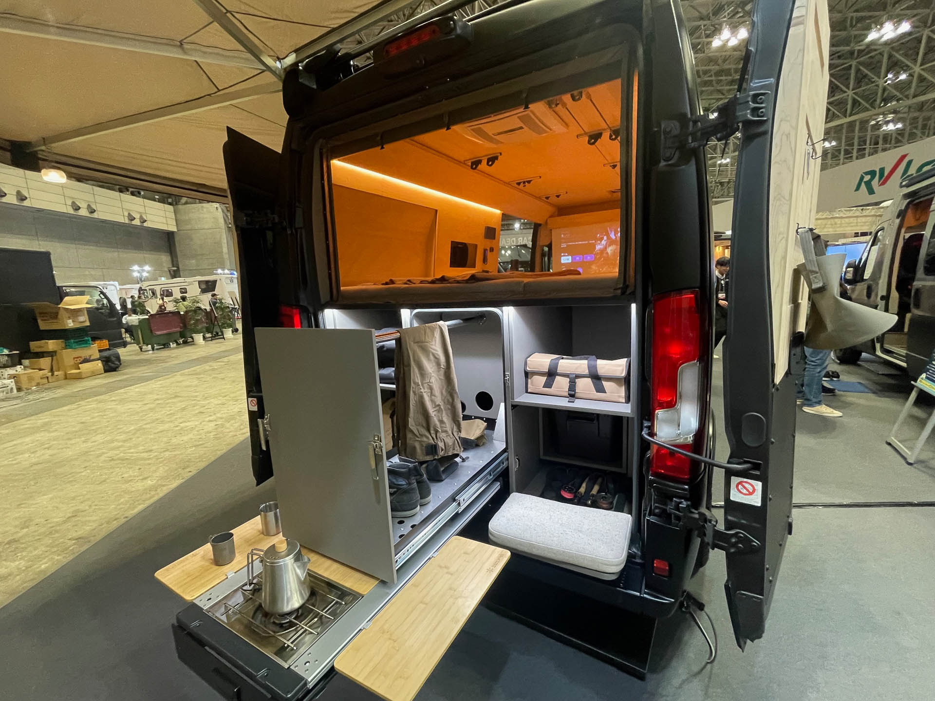 キャンプ仕様のリアエンド。収納棚を引き出した状態。調理器具を収納している