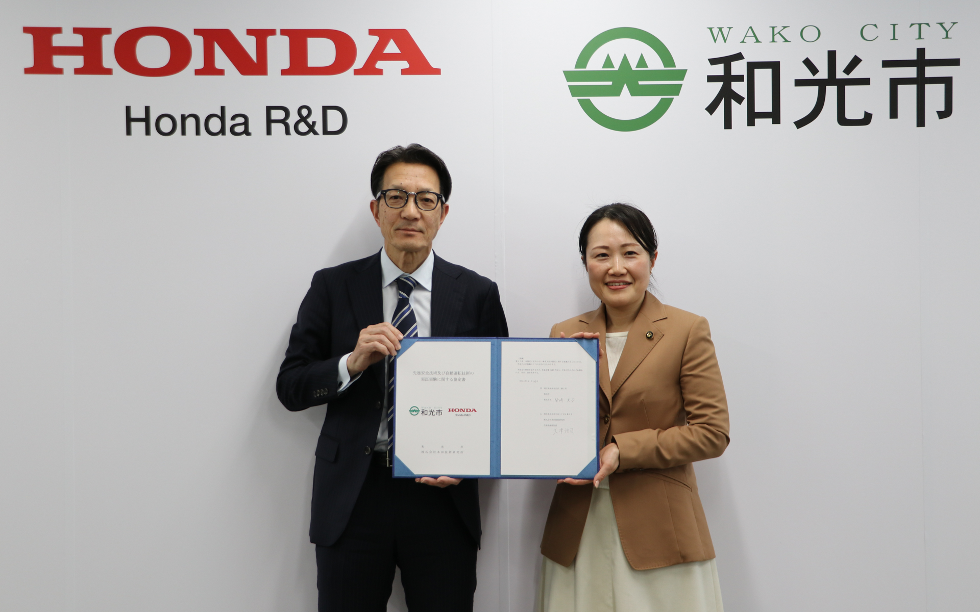 協定書を持つ株式会社本田技術研究所 代表取締役社長 大津啓司氏（左）と埼玉県和光市 柴﨑光子市長（右）