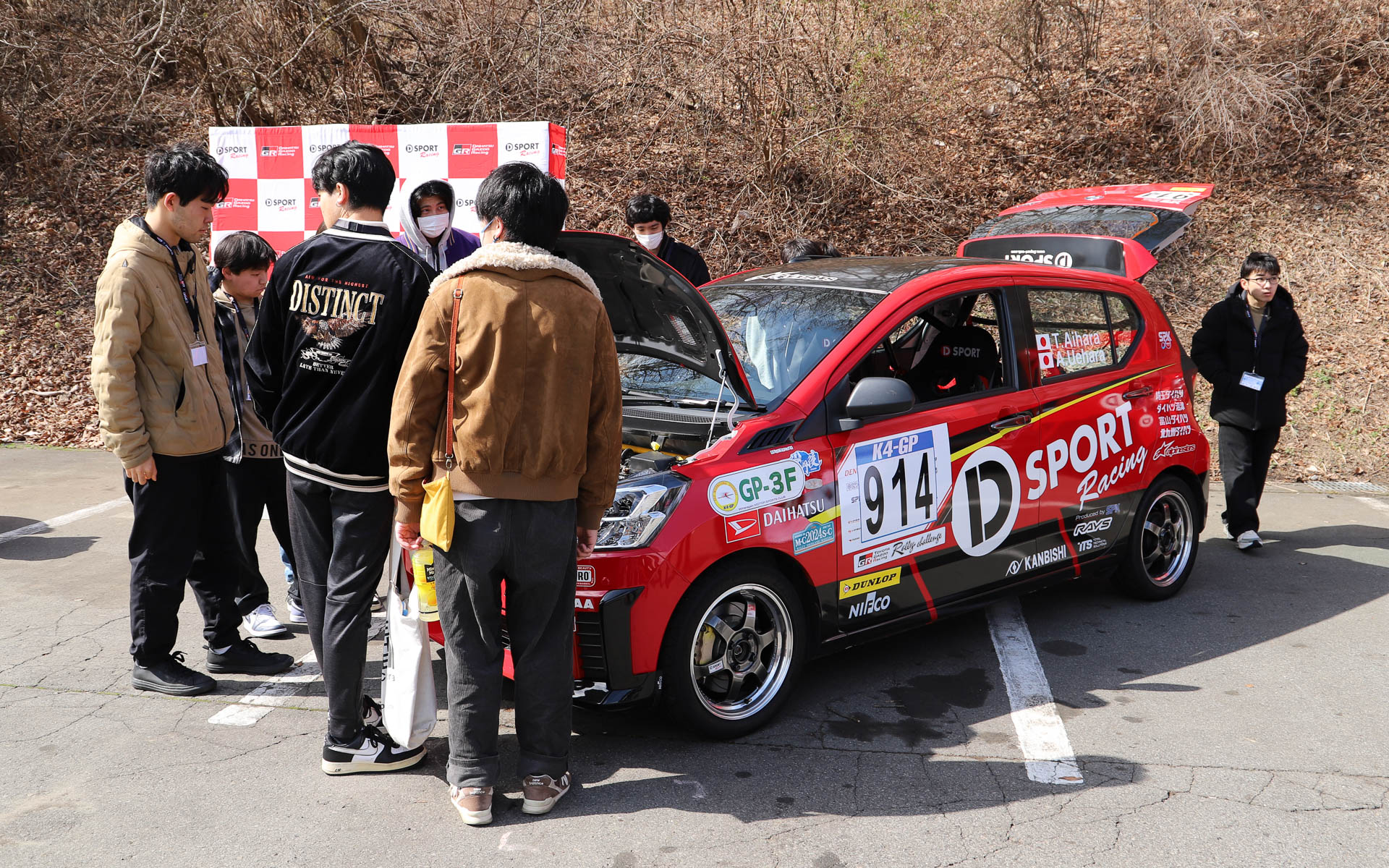 学生たちは展示されたレース車両を興味津々に見ており、相原氏やスタッフが車両の説明を行なう姿が見られた