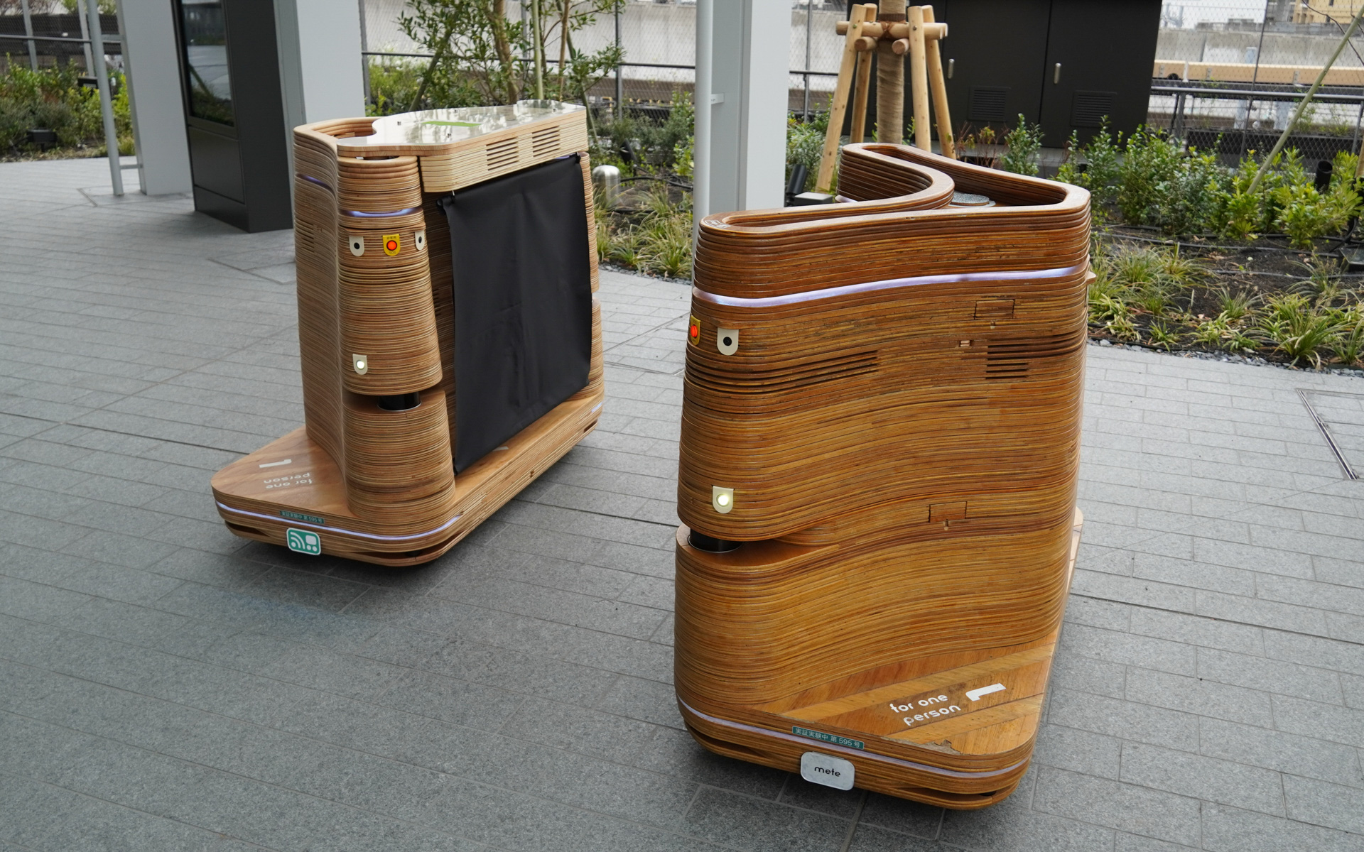 TAKANAWA GATEWAY CITYで誰でも乗れる自動走行モビリティ「iino」。左側のiinoは2人乗車だが乗っている間は“スマホを休ませてみよう”でワイヤレス充電できる