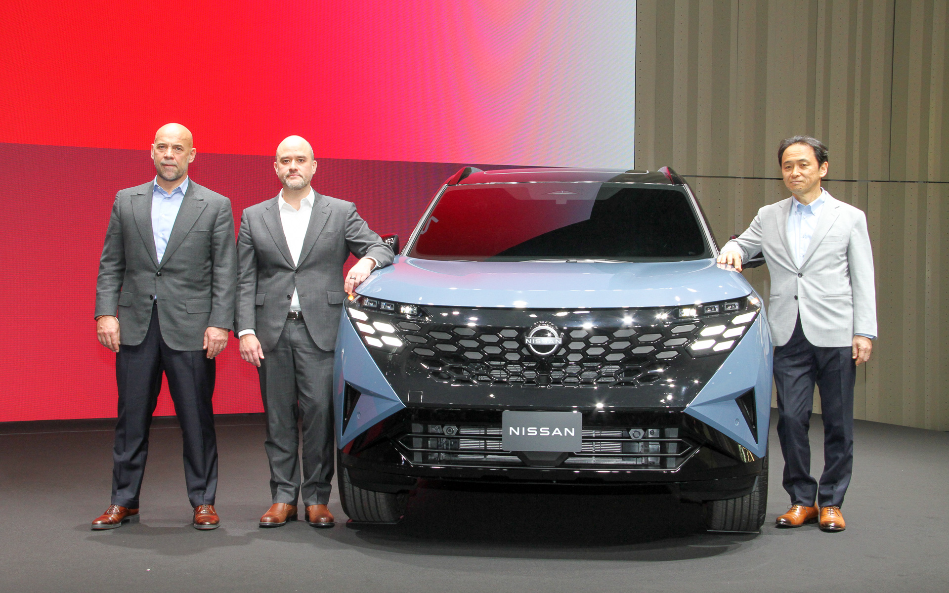 新型「エクストレイル」と写真に納まる日産自動車株式会社 CEO イヴァン・エスピノーサ氏（中央）、チーフ テクノロジー オフィサーの赤石永一氏（右）、チーフ パフォーマンス オフィサーのギョーム・カルティエ氏（左）