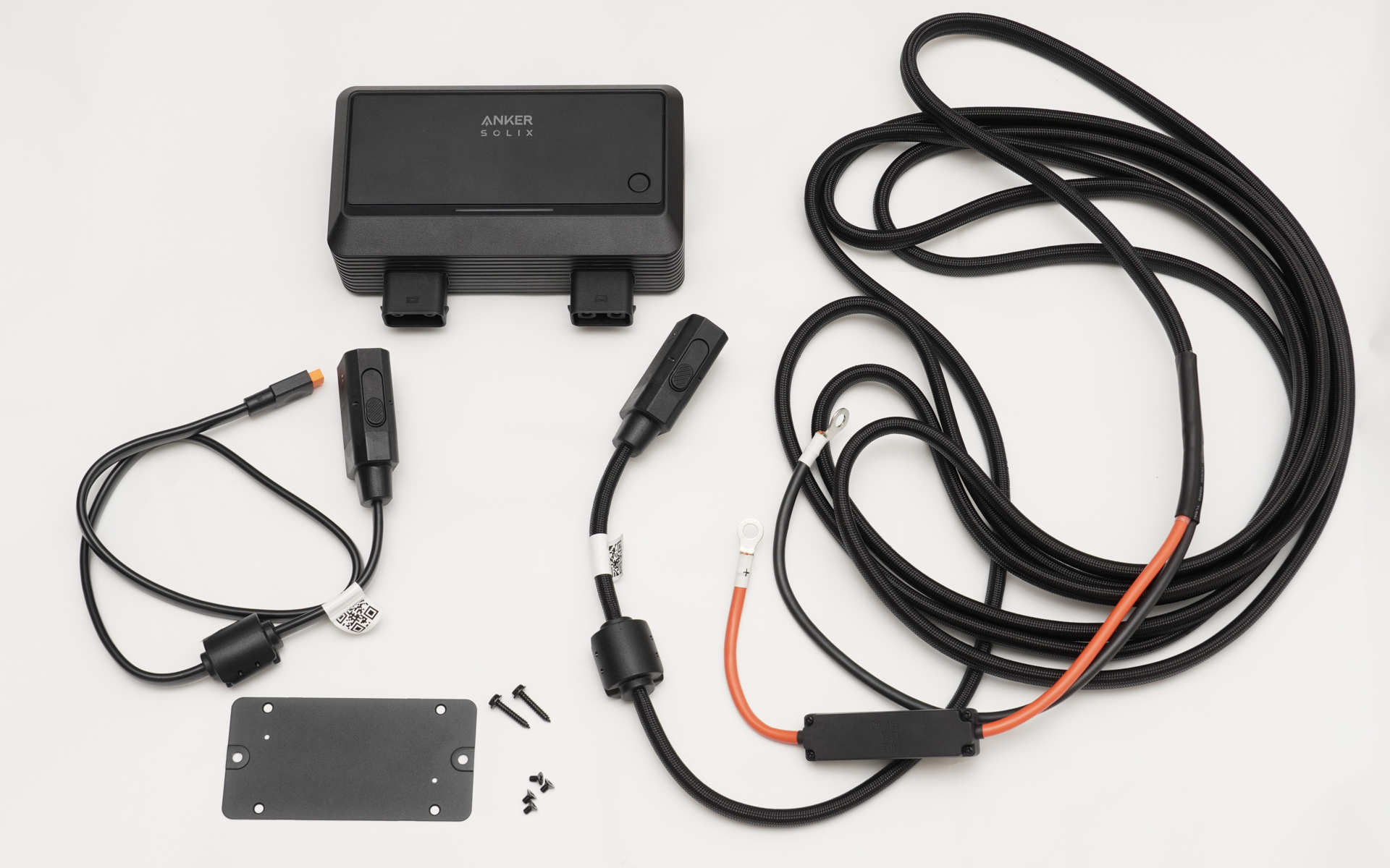 Anker Solix オルタネーターチャージャーとその付属品。ケーブルが2本と取り付けプレートとネジ