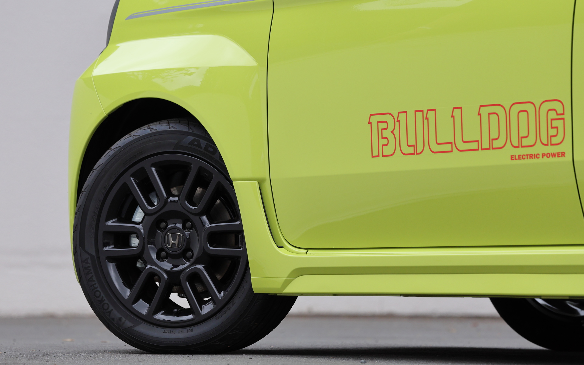 会場には標準車以外にホンダアクセスの純正アクセサリーによるエクステリアコーディネイト「BULLDOG STYLE（ブルドッグ スタイル）」モデルも展示。シティ・ターボIIの書体を再現した「BULLDOG」デカールをはじめ、スポーティな走りを想起させる「テールゲートスポイラー」、発光色のイエローとクリアの切り替えが可能な「LEDフォグライト バイカラー」、ベルリナブラックの「15インチアルミホイールME-027」、スーパーワンの車名プレートも付属する「ブラックエンブレム」を装着。インテリア向けとしてはスポーツペダルやUSB PDチャージャー（Type-C）なども用意される