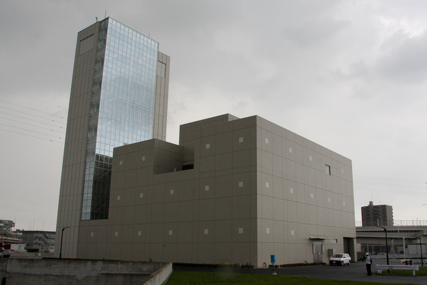 大師JCTにある換気所。トンネル内の空気を吸い出し、高さ45mの換気塔から上空に向かって噴出する。排出する前には、SPM除去装置や低濃度脱硝装置などで空気をきれいにしている