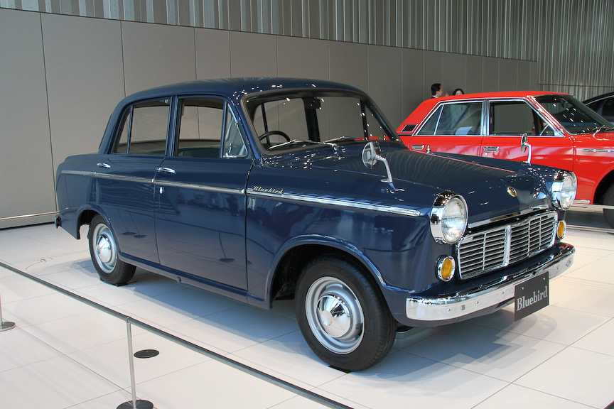 発表会会場のグローバル本社ギャラリーには、「幸せを運ぶ青い鳥」とのキャッチコピーがつけられた初代「ブルーバード 1200スタンダード」（1959年、写真左）と、高級オーナーカーとして発売された初代「ローレル 1800デラックスB」（1968年）が展示してあった