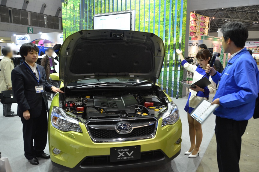 ボンネットを開けてエンジンの説明をしているシーン