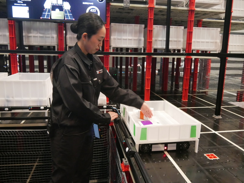 ピッキングした商材を配送用コンテナに入れる