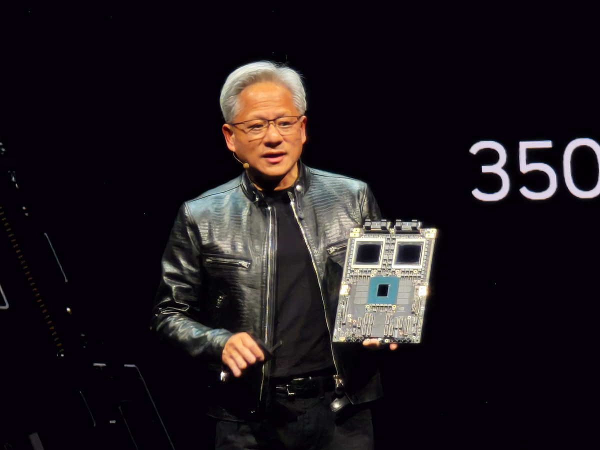 NVIDIA CEO ジェンスン・フアン氏が手に持っているのがGB200のボード。上の黒く見える2つのチップがB200、下の緑がGrace CPU（2024年のCOMPUTEXで撮影）