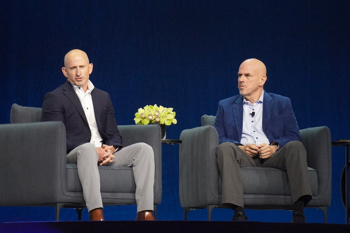Spectrum 人事技術・AI戦略担当副社長 デレック・ドレイファス氏（左）、Oracle CEO マイク・シシリア氏（右）