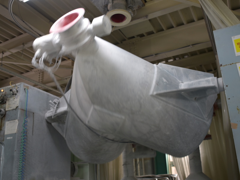 V字のブレンダーが回転し、粉末の原料を混ぜ合わせる