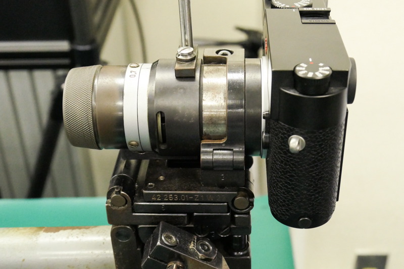 試験機にカメラを取り付けたところ。距離リングを回してファインダー内のフレームを動かし、パララックス補正が適正かチェックする。