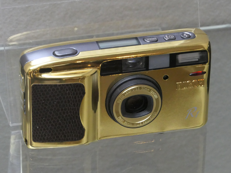 リコーR1ゴールド（平成8/1996年）。リコーR1が世界各国で5つの賞を受賞したことを記念して少量生産したモデル。24金のメッキが施されている。