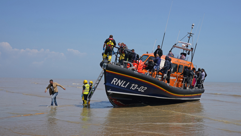 <span class="fnt-85">A group of people thought to be migrants crossing from France come ashore from the local lifeboat at Dungeness in Kent, after being picked-up following a small boat incident in the Channel. Picture date: Tuesday July 20, 2021.  Photograph: Gareth Fuller</span>