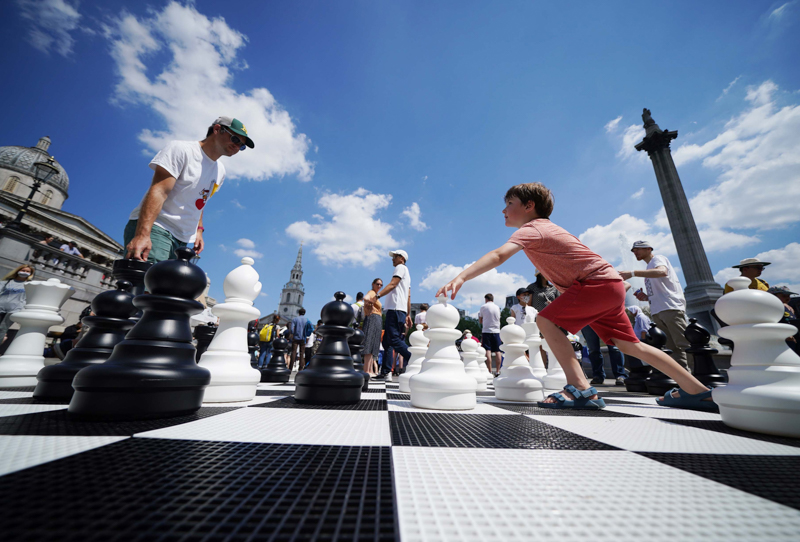 <span class="fnt-85">Father and son Graham and Innes McClelland play chess in Trafalgar Square, London as part of ChessFest, organised by Chess in Schools and Communities (CSC), a charity that uses chess to help children's educational and social development. Picture date: Sunday July 18, 2021.  Photograph: Yui Mok</span>