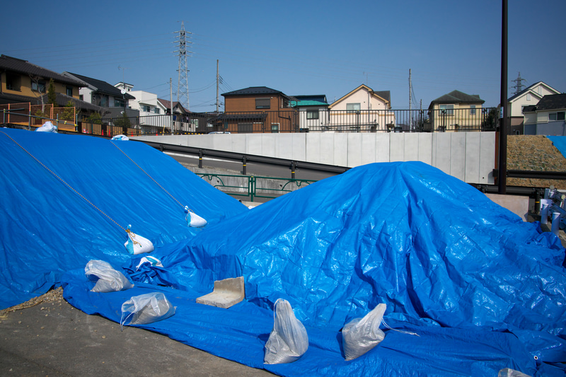 道路予定地の光景ですね。筆者はブルーシートに反応するらしくシャッターを切る性癖があります。28mm“相当”の画角ではなくて、正統派の28mmでの撮影が嬉しいこともあります。<br>Z 9　NIKKOR Z 28mm f/2.8（Special Edition）（F8・1/2,500秒）ISO 400