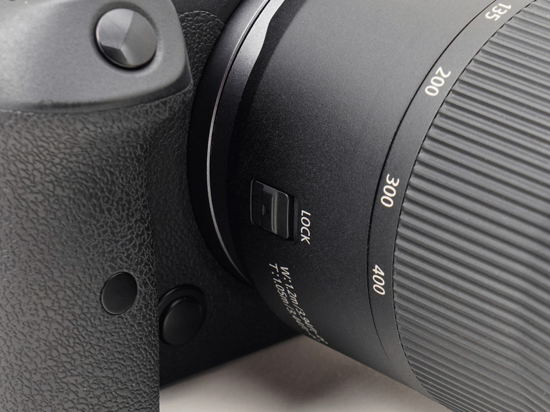 鏡筒の右側面（カメラを構えた状態で右）には、ズームリングロックレバーがあります。カメラを肩にかけて移動するときなどに、勝手に鏡筒が伸びないよう固定するものですが、こうした伸縮の幅が大きなズームレンズには嬉しい機能です。