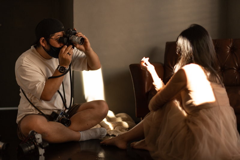 LEDライトの光をいのうえさんの背中や手にあてている