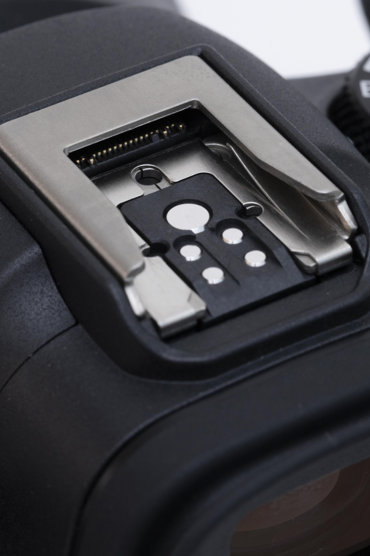 左はEL-5のシュー接点部、右がR6 Mark Ⅱのマルチアクセサリーシュー。R6 Mark Ⅱのマルチアクセサリーシューに注目してほしい。奥に見える金属部に、シュー接点部の先端が接続されるわけだ。なお、購入時はそれぞれカバーが同梱される（中央）。使用しないときはカバーをつけて保護しよう