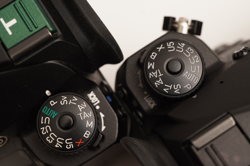 モードダイヤルで比較。左は私物のベースモデル。右が本機で、文字の色はうっすらとグレーを帯びている。ダイヤルの下にあるロックレバーの表示は、それより濃いグレーだ