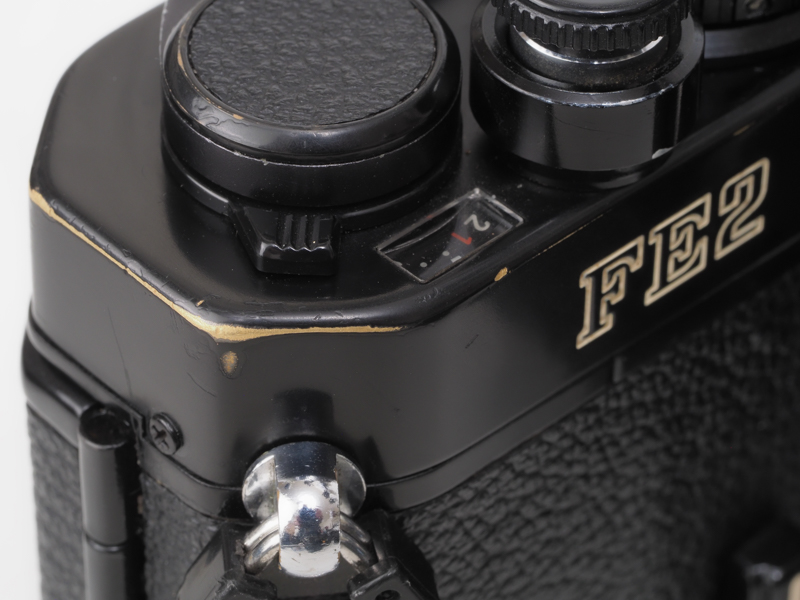 ニコンFE2のブラック塗装は耐摩耗性に優れます。40年使用してもこの程度。ライカのブラックペイントみたいにベロっと剥がれない。Z fはマグネシウム合金だから、剥がれても今一つの質感。頑張って真鍮製のシャッターダイヤルの塗装を剥がれるほど使いましょう。あ、40年使うことがありえないか（苦笑）