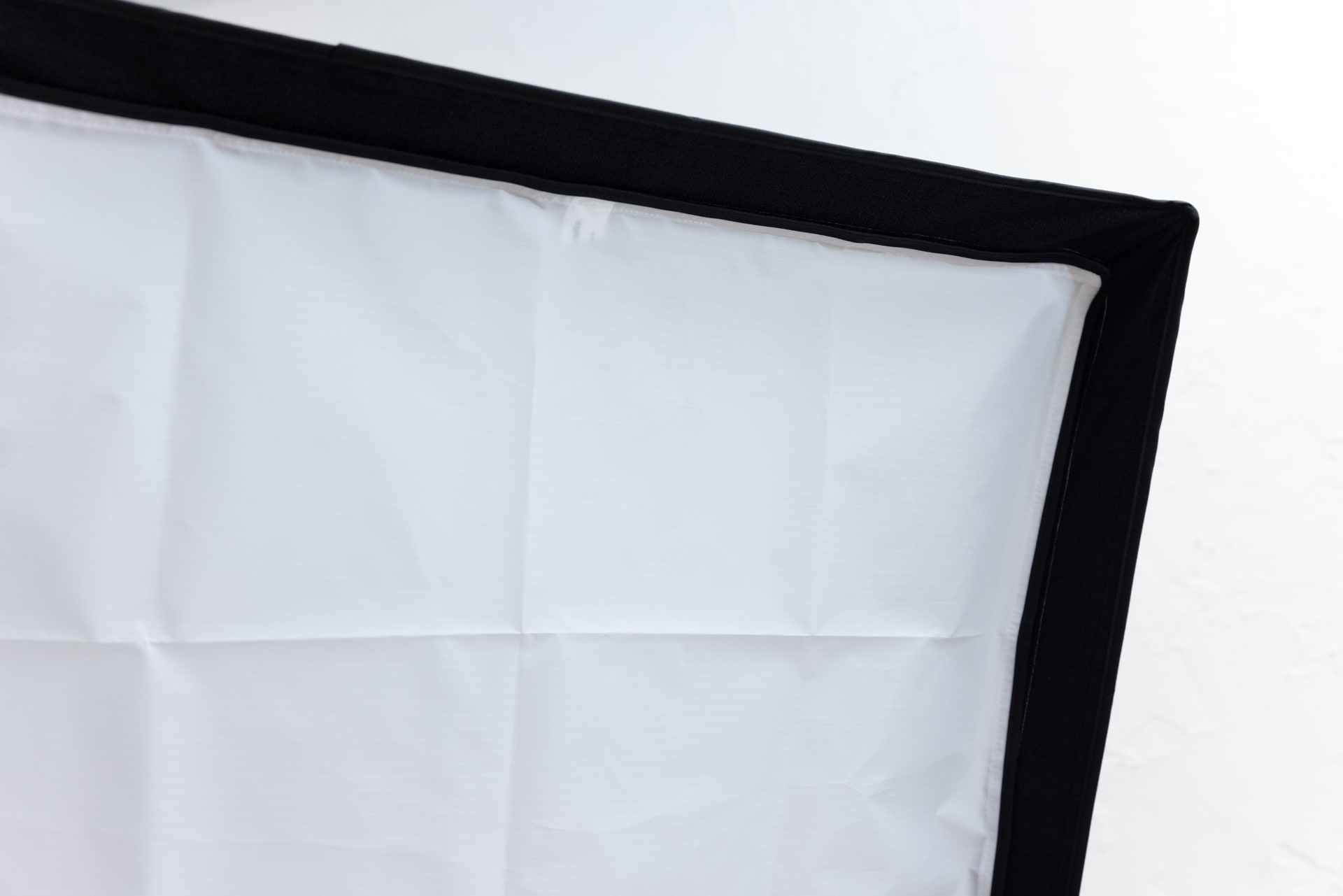 外側のディフューザーはフチの白い線に合わせて取り付ける。なお、ソフトボックスのフチは光が周囲に漏れないように、光をコントロールするための大事な役割を担っている。また、後述のグリッドはこのフチに取り付ける仕様になっている