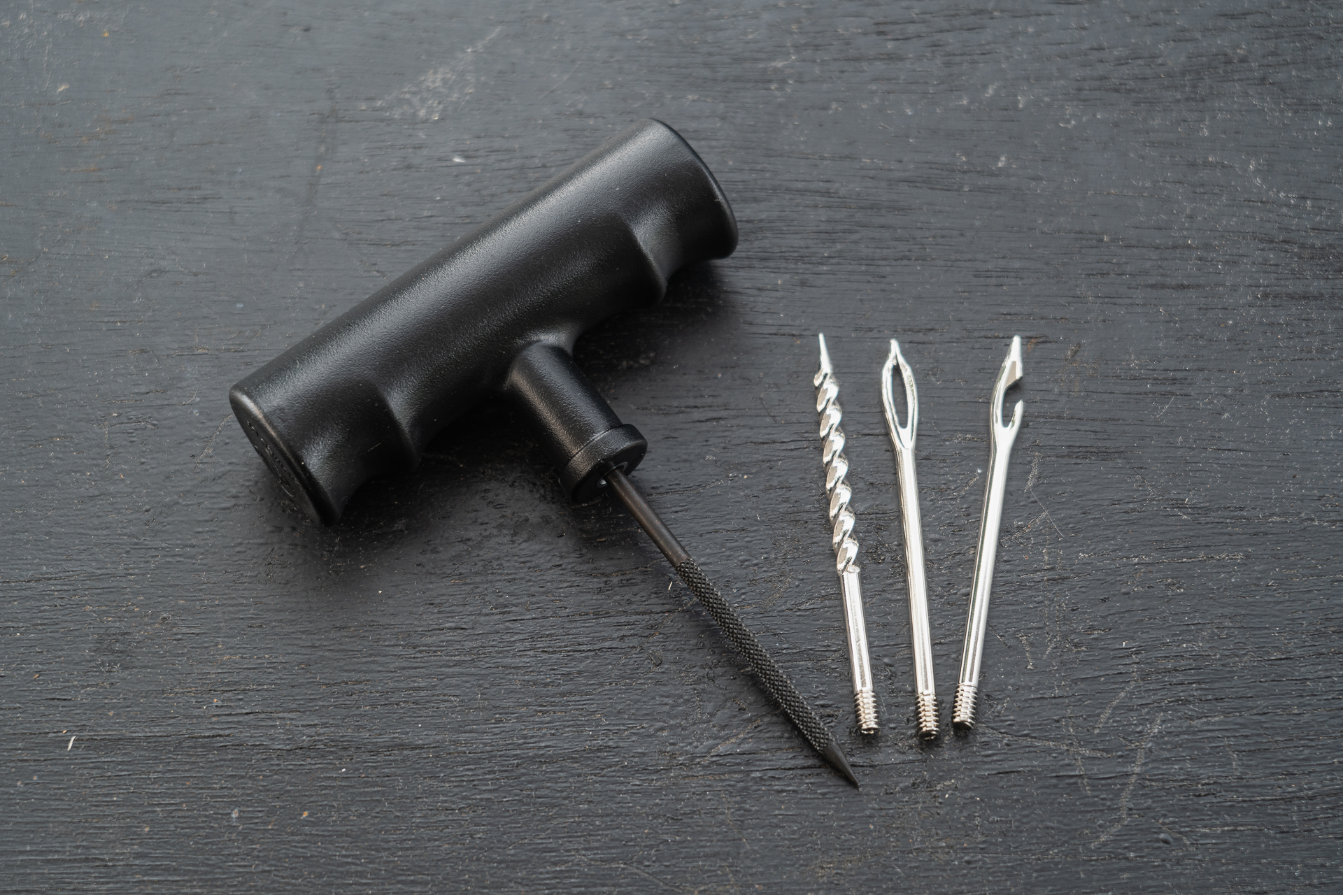 ハンドルについている黒いブレードはヤスリになっています。これと右隣のスパイラル状のブレードを使ってパンク穴を整えます。右2本はリペアゴムを挿入するためのもの。穴によって使い分けるらしいのですが、正直どちらが良いのかわかりません。今回は右から2本目を使いました。穴の先が割れていて、リペアゴムが抜けるようになっています