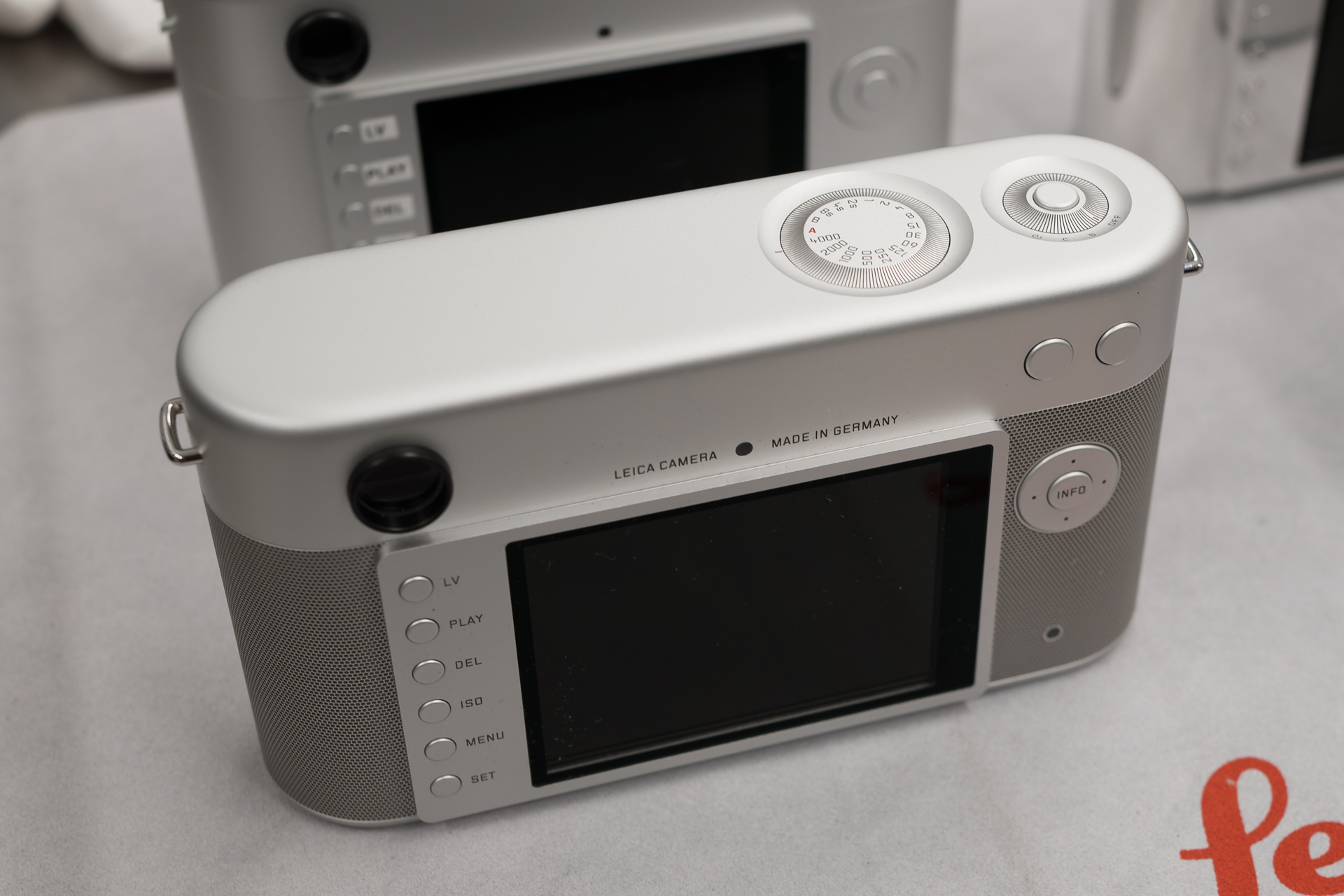 天面のダイヤルも独特だ。ホットシューやEVF端子は省略。マイク穴と録画ボタンも見当たらないので、動画機能ごと省略されているのかもしれない。