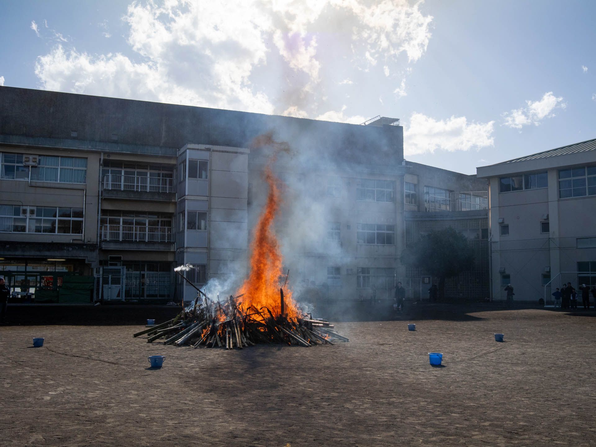 どんど焼き。強風だったのでヤグラを小さくしたということで、しょぼいのですが、炎の魅力は昨年とたいして変わらず。<br><span class="fnt-85">LUMIX G9PROII／SIGMA 19mm F2.8 DN／19mm（38mm相当）／プログラムAE（1/1,600秒、F8.0、−0.7EV）／ISO 400</span>