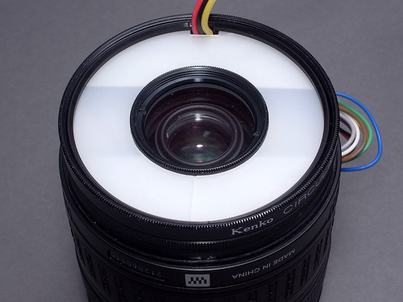 <b>発光部ユニットを、レンズ先端にねじ込むとこんな感じ。これで「最小のマクロストロボ」はひとまず完成である</b>