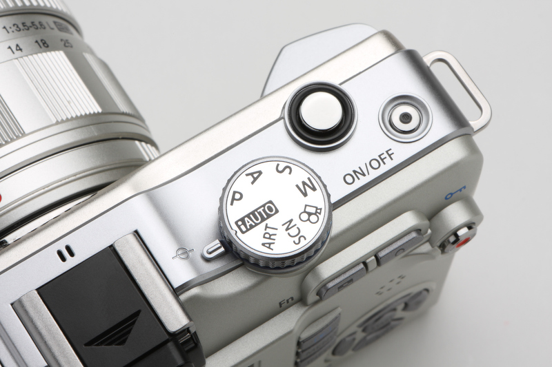 <b>E-P2/P1ではカメラ上部左側にあったモードダイヤルは、シャッターボタン側に備わる。電源ボタンはONになると青いLEDが点灯する</b>