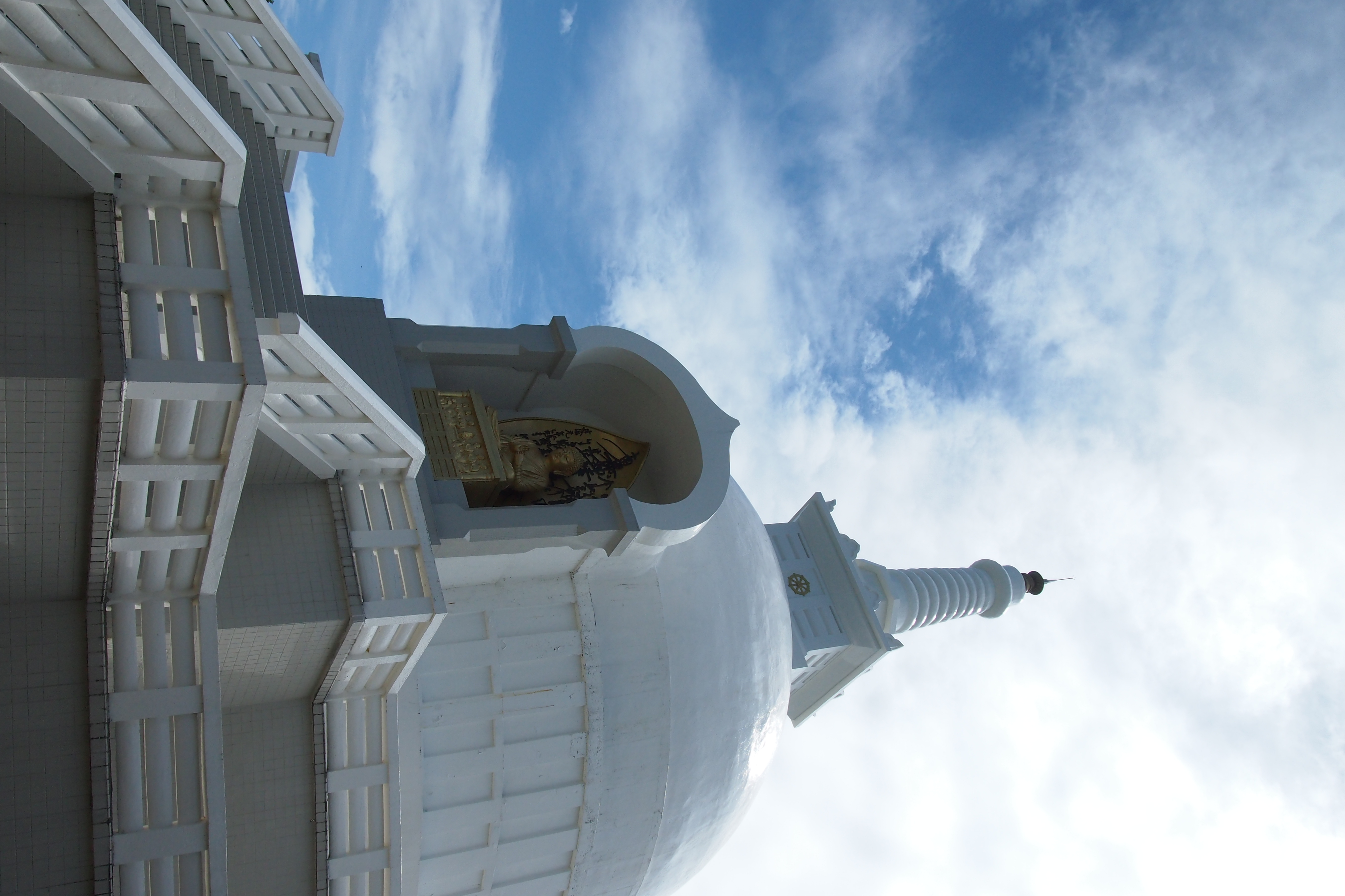 <b>麓からは樹々に隠れて白い塔しか見えないが、仏様がいらっしゃる。ちなみにここも工事中なのであった。E-P3 / M.ZUIKO DIGITAL 14-42mm F3.5-5.6 II R / 4,032×2,688 / 絞り優先AE / 1/2,000秒 / F8 / 0.3EV / ISO400 / WB:太陽光 / 14mm</b>