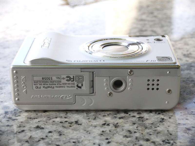 <b>底面。三脚用ねじ穴の右側（バッテリーカバーの反対側）にある9個の穴はスピーカー</b>