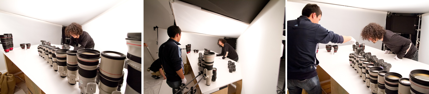 <b>キヤノンのEOSシリーズ、EFレンズなどの全製品ラインナップの他に、製品発表はあったものの、未だ発売前の新機種EOSのデジタルシネマカメラC300や交換レンズなどを含むので超極秘撮影現場だったので、さすがのボクも少しだけ緊張。ズラリと並んだ機材群をみると、今、誰かがコードに足を引っかけたりして倒れたら大変だあー、なんてあってはならない想像をしてしまう小心者の自分がいる。しかし、当たり前だがモッチーはそんなことは関係なく、手際よく並べていき、若干の位置や回転方向をスタッフのみんなと一緒に修正していく。セットの裏手へ回り込んだボクが一番気を付けなければならないのは新製品をはじめ本日の撮影モデルである、カメラ&レンズを倒したりしないように努めることだった。</b>