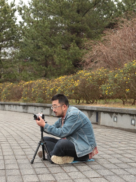 <b>列の最前列で撮影するときは、地面に座る姿勢で三脚をセッティングすると後で見る人にも邪魔にならない。また三脚のスペースも一番狭く設置することができる</b>