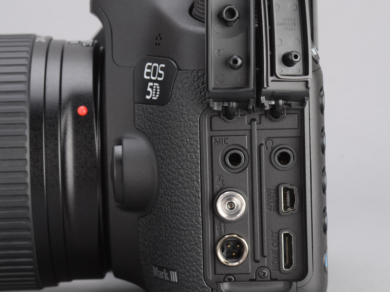 <b>シンクロやHDMI、USB、ヘッドフォン、マイク端子などが並ぶインターフェース部。ラバー製カバーは各列ごとに独立したタイプ。例によって1度開けると閉めるのが結構大変。防塵防滴性を確保するためにキツめになっているのは当然だが、デザイン的にも決して美しいとは言えず、そろそろ何かいいアイデアはないだろうか。</b>