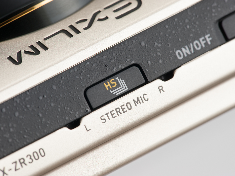 <b>連続撮影切替ボタンは、高速連写のモードに切り替えるためのもの。その両側の穴はステレオマイク。</b>