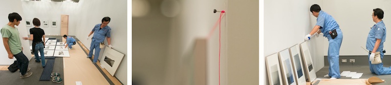 <b>東京都写真美術館で現在開催中の田村彰英写真展「夢の光・Light of Dreams」。展覧会の前日、作品展の搬入、展示の現場を取材させていただいた。ボクが現場へ入った時には額装された作品の搬入そのものは終わっていて、展示位置の調整やライティングの設定などの作業中だった。展示や照明にはそれぞれ専門の業者さんたちが大勢いて、テキパキ正確に進んでいった。展覧会の設営風景を取材に来たはずだが、上質な職人芸をみせてもらった気分でうれしくなってしまった(笑)。今回の展覧会は田村さんのデビューからの作品の歴史を辿る展示だが、写真作品だけではなく田村さんのコレクションでもあり、実際の「赤陽」シリーズの撮影にも使われた8×10カメラやオールド・レンズも展示されている。また短い映像作品もあるので、いろんな側面から楽しめるようになっている。</b>