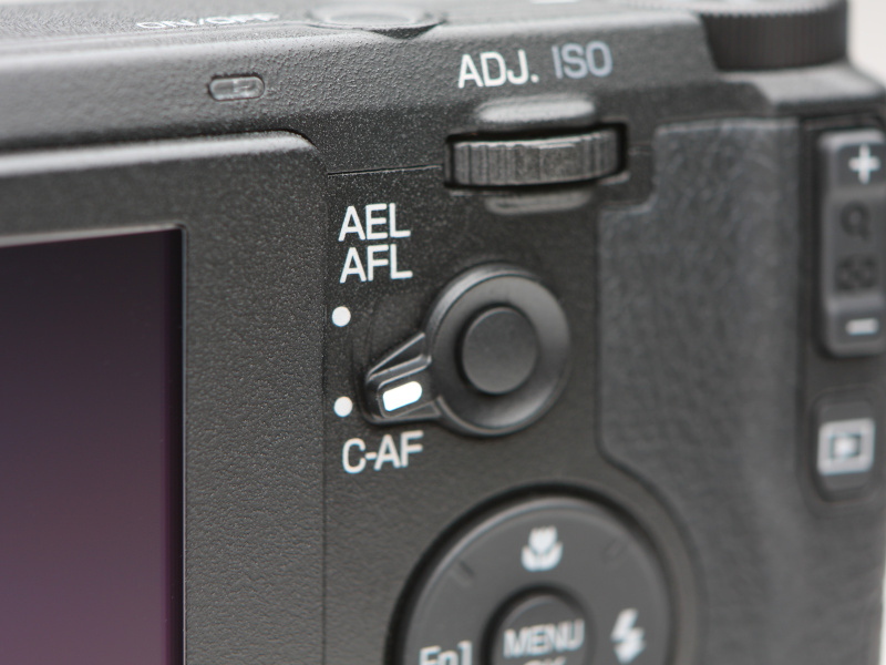 AEL/AFLとC-AFの切り換えレバーと同軸のボタンは、いわゆる“親指AFボタン”で、 このボタンを押すとAFを開始する。親指AFを常用する一眼レフユーザーは、使いやすく感じるはずだ。