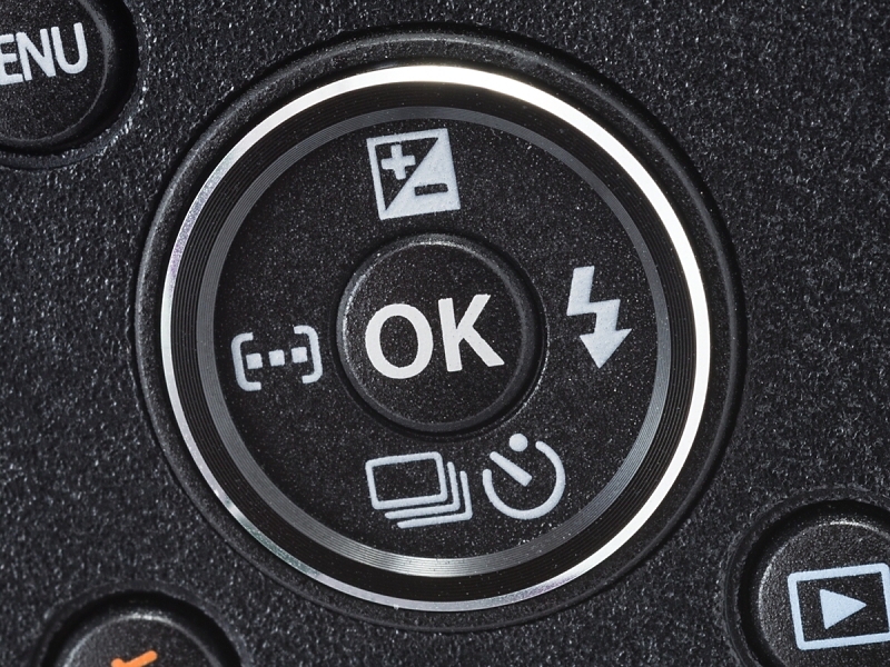 背面の十字ボタン。右ボタン（フラッシュモード）と下ボタン（ドライブモード）は機能の変更が可能になっている。