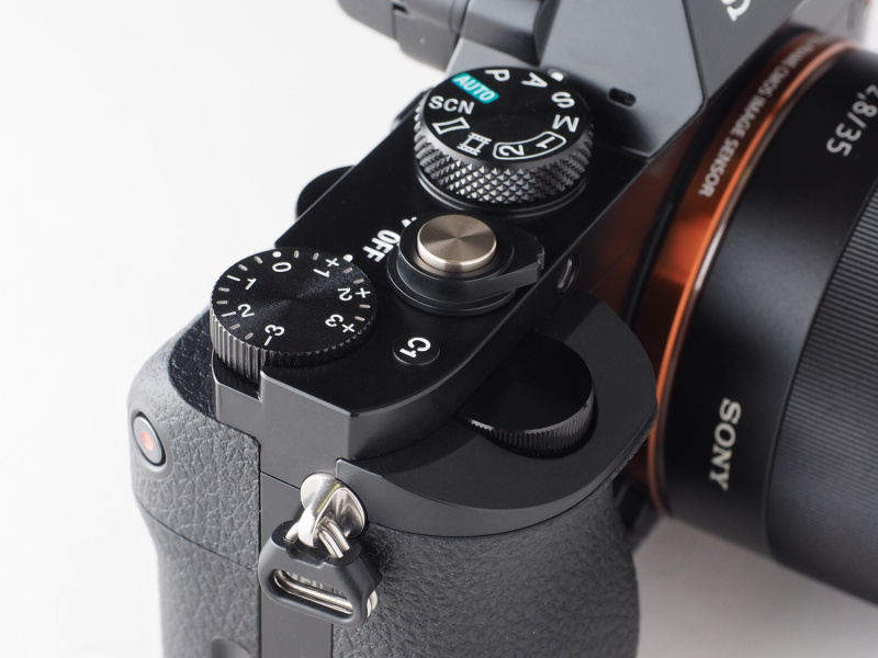 シャッターボタン周辺。露出補正ダイヤル、前後ダイヤル、カスタムボタンなど上級機としての操作系を装備している。