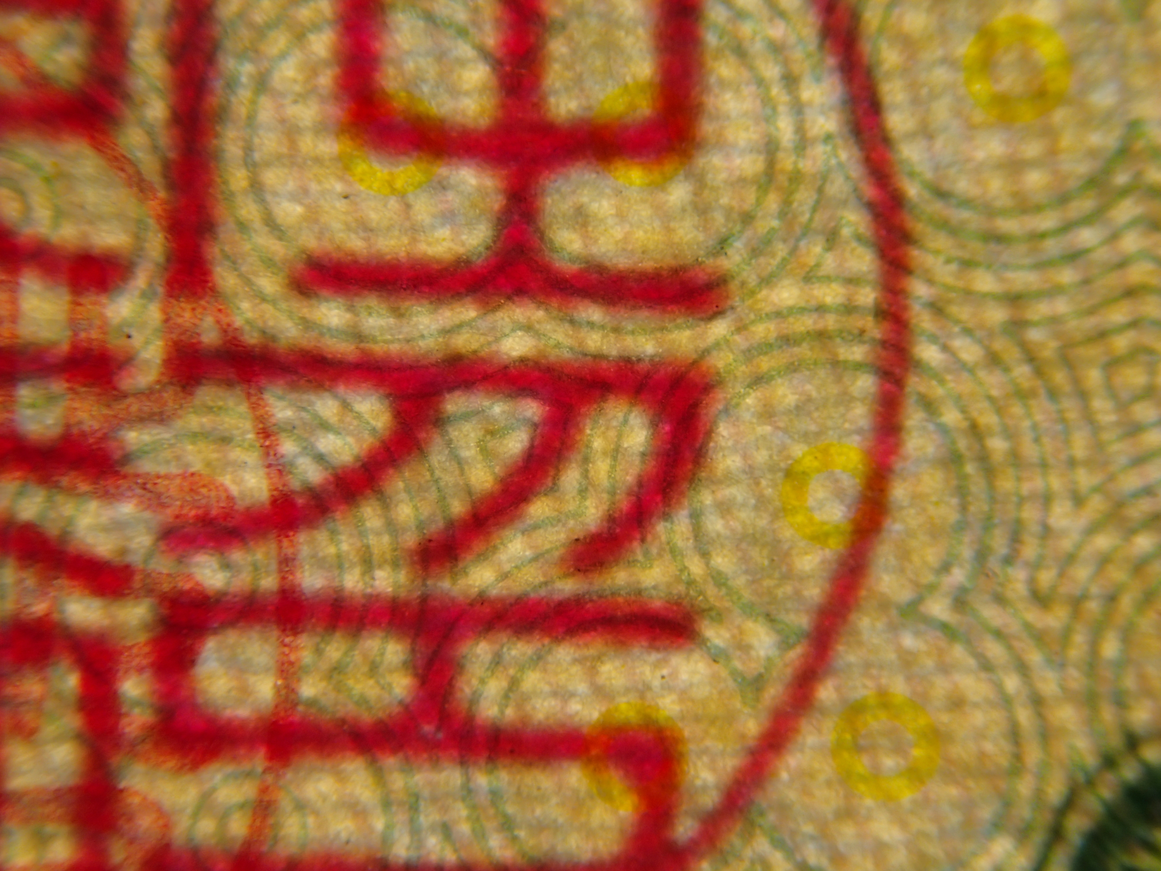 裏面に印刷された渦巻きのような模様と、表面に押された印鑑（総裁之印）の重なり。