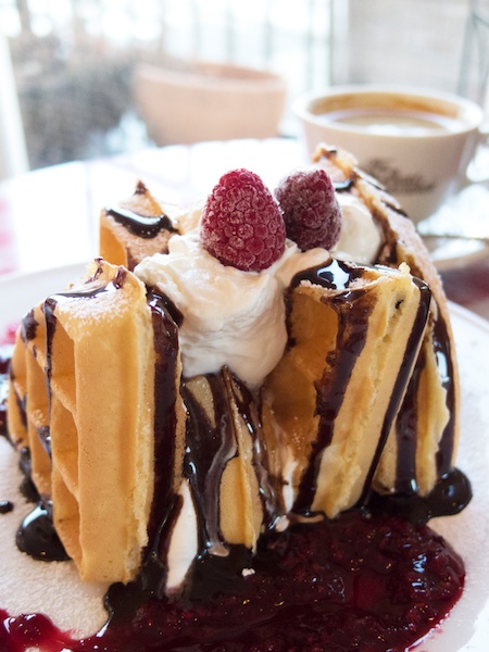 主役は手前のワッフル。奥にコーヒーカップを配置してボカすことによってワッフルが目立ちます。また、その奥にテラスがボケて写っているので、さらに遠近感が強調されました