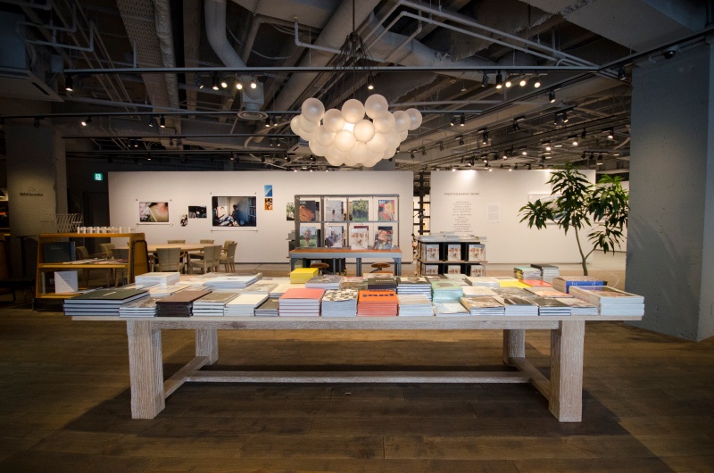 エントランスを入ると目に飛び込んでくる大きな平台。たくさんの写真集が並んでいます。奥の壁の向こうがギャラリーです。