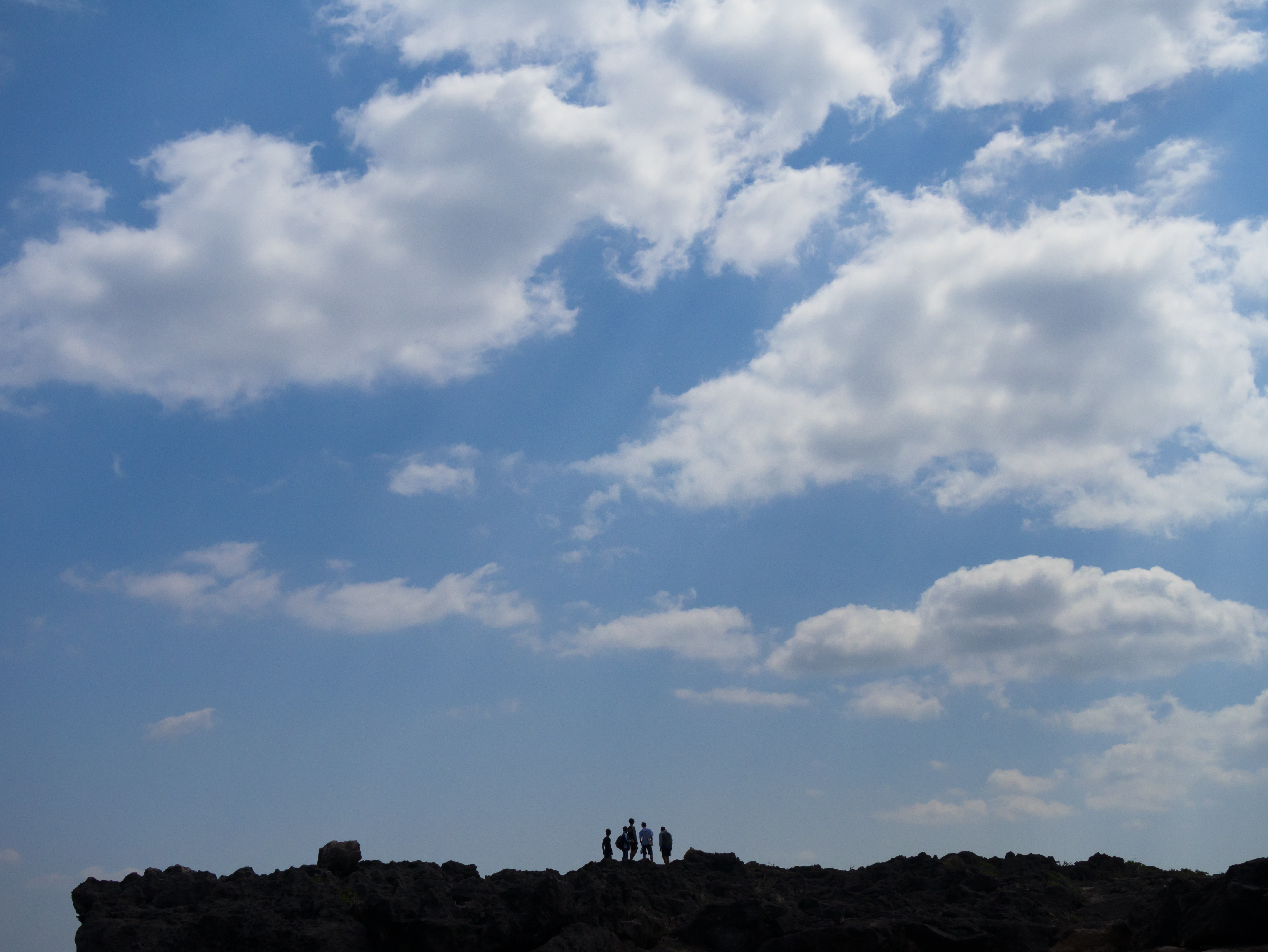 崖の上に立つ男たちをロングショットで撮影。太陽がやや逆光気味に差していたが、チルト可動式の内蔵EVFを使うことで、画面四隅までをきっちり確認しながら構図を決めることができた。LUMIX DMC-GX7　LUMIX G VARIO 14-140mm/F3.5-5.6 ASPH./POWER O.I.S.　F5.6　1/2,500　-0.7EV　ISO200　WB:晴天　24mm