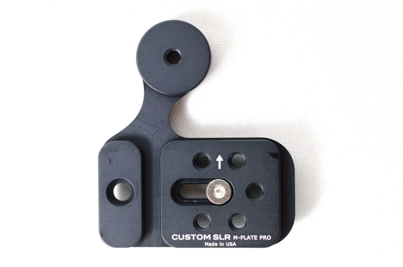 M-PLATE PRO（税別8,780円）。カメラの三脚穴に固定するねじは可動式。ストラップアダプターC-Loopを装着できるアームがある。