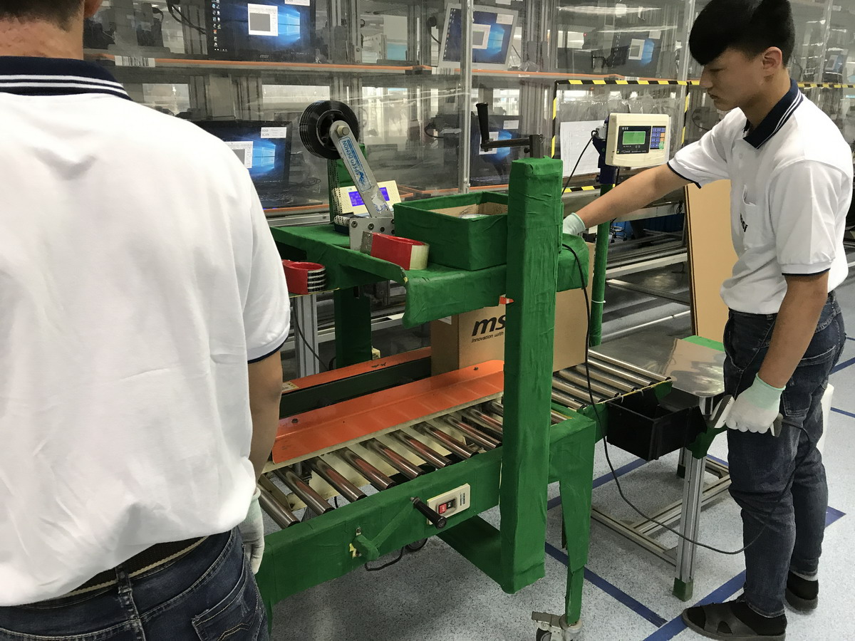 開口部を自動的にテープ止めする機械