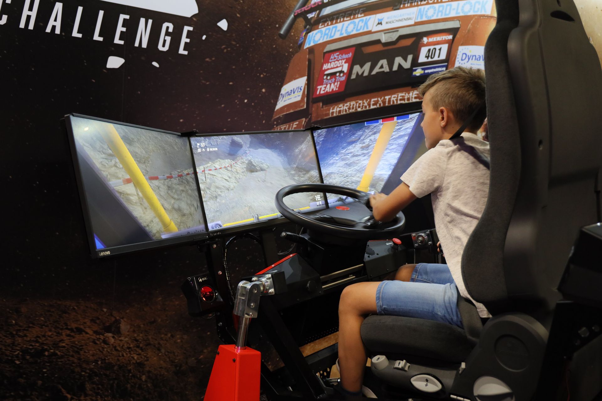 手慣れた手つきで乗りこなす少年。このシミュレーターのような巨大なハンコンが欲しくなるゲームだ